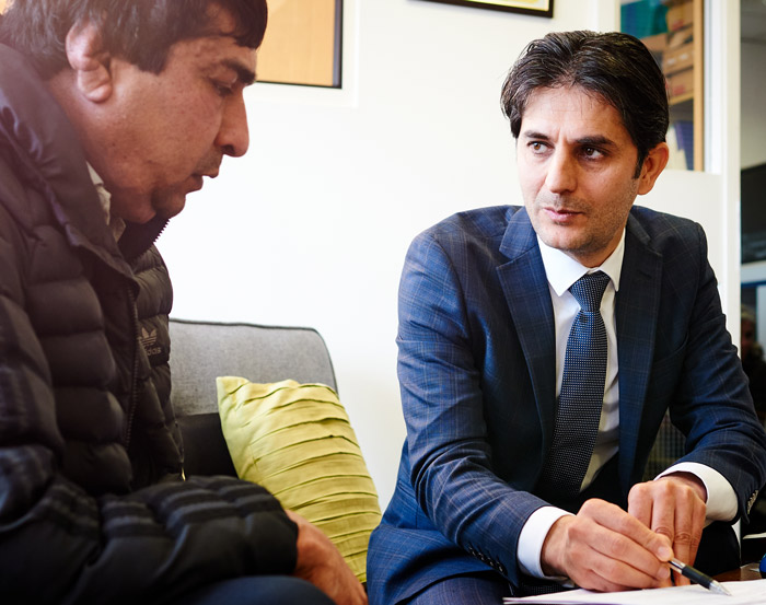 Man giving advice to asylum seeker in office