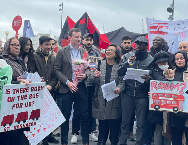 Group of refugees holding signs at protest