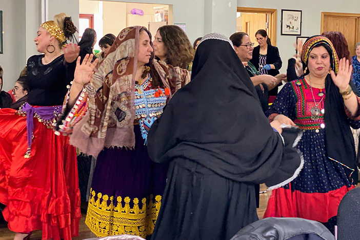 Women dancing in traditional clothes at social event